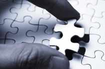 Hands placing a puzzle piece into a larger puzzle, representing whole-person care
